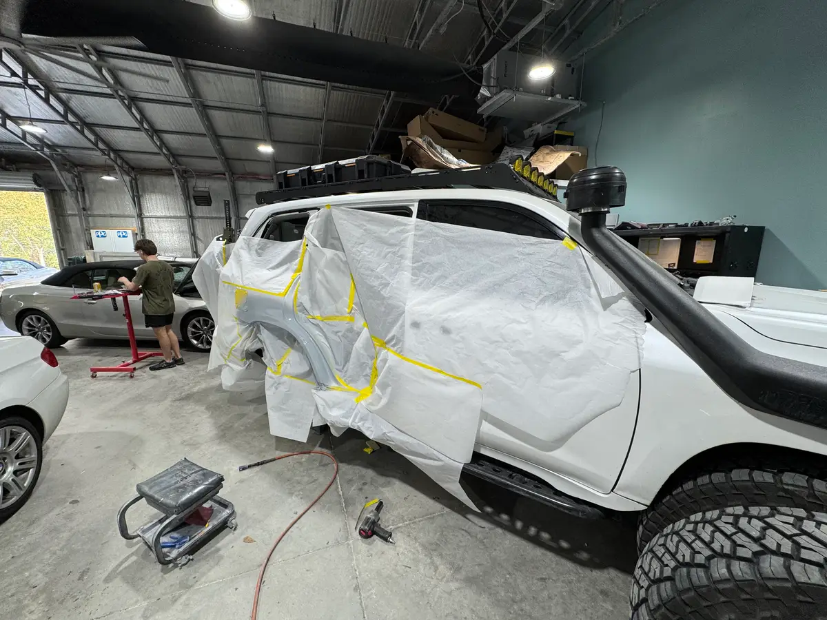 SUV masked for paint repair during collision work Charleston SC
